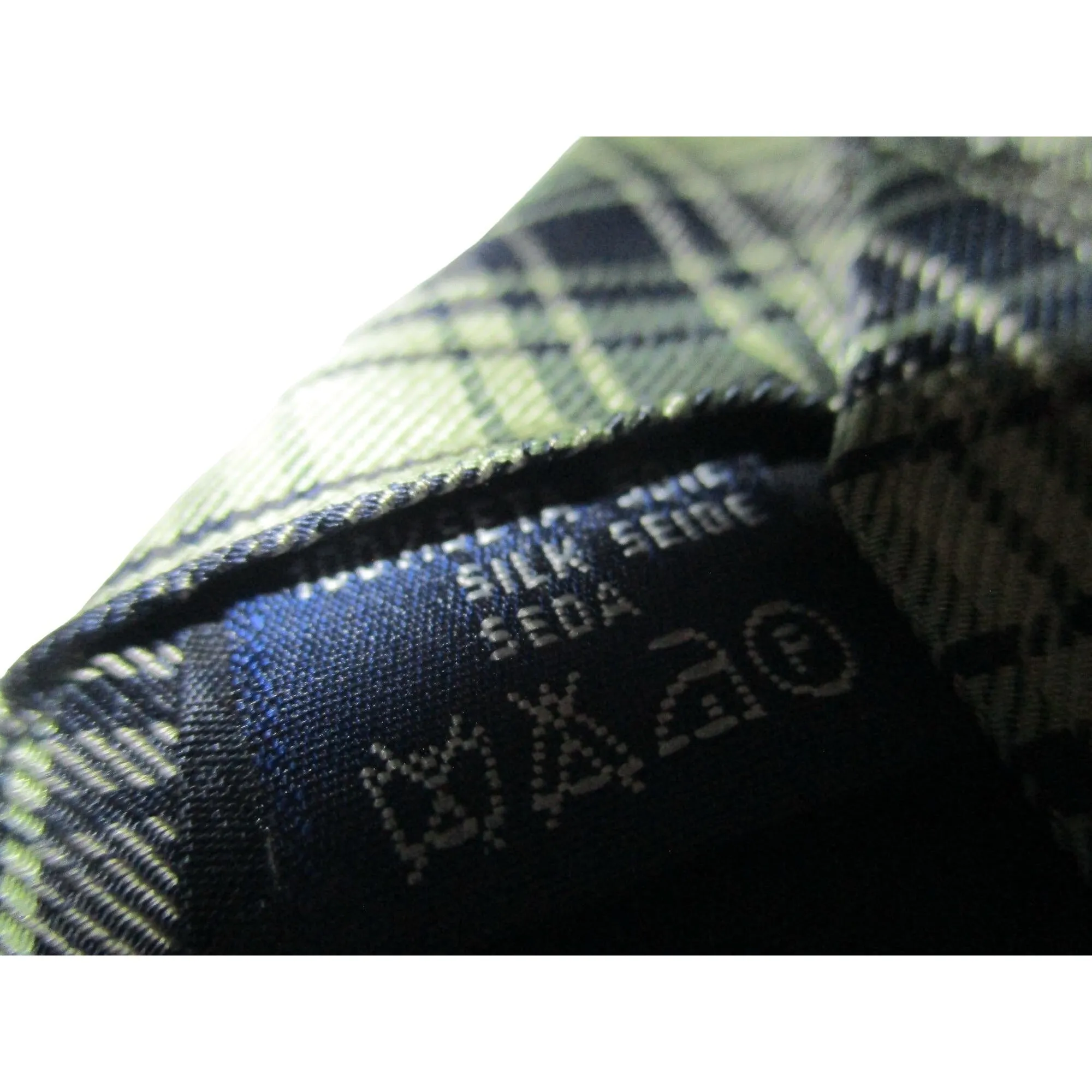 Vintage Burberry's of London tie made of 100% silk with an iconic plaid print with knights in shades of blue, yellow, and green